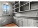 Spacious pantry area with custom cabinets, granite countertops, a sink, and lots of open shelving at 56 Pine St, Roswell, GA 30075