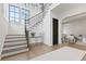 Elegant staircase with modern railing, hardwood treads, and white risers in a bright foyer at 56 Pine St, Roswell, GA 30075