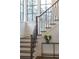 Elegant staircase with modern railing, hardwood steps, and natural light at 56 Pine St, Roswell, GA 30075