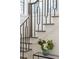 Elegant staircase with dark railing, hardwood steps, and a modern glass vase at 56 Pine St, Roswell, GA 30075