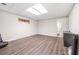 Finished basement area with laminate flooring, and recessed lighting, with adjacent storage area at 959 Vendue Dr, Lawrenceville, GA 30044