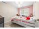 Pink bedroom featuring a white-frame bed and a chandelier at 959 Vendue Dr, Lawrenceville, GA 30044
