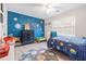 Themed bedroom with custom blue space-themed wall design at 959 Vendue Dr, Lawrenceville, GA 30044