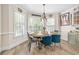 Bright dining room featuring a round table, chandelier, and large windows that offer natural light at 959 Vendue Dr, Lawrenceville, GA 30044