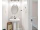 Small bathroom featuring pedestal sink, updated fixtures and hardware plus a door to additional rooms at 959 Vendue Dr, Lawrenceville, GA 30044
