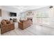 Cozy living room with a stone fireplace, neutral-toned furniture, and natural light streaming through large windows at 959 Vendue Dr, Lawrenceville, GA 30044