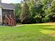 Lush backyard featuring a deck with stairs and ample green space at 102 Avalon Ct, Canton, GA 30115