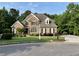 Beautiful brick home features a well-kept lawn and mature trees at 102 Avalon Ct, Canton, GA 30115