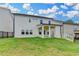 Spacious backyard featuring a covered patio and lush green lawn at 1620 Branthaven Ln, Auburn, GA 30011
