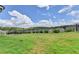 View of expansive backyard with iron fence, trees in the background at 1620 Branthaven Ln, Auburn, GA 30011