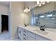 Bright bathroom featuring double vanity, white cabinets, matte black fixtures, and glass shower at 1620 Branthaven Ln, Auburn, GA 30011