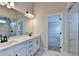Elegant bathroom with dual sink vanity, marble-look floors, and glass shower at 1620 Branthaven Ln, Auburn, GA 30011