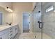 Modern bathroom featuring double vanity, glass shower door, and marble style flooring at 1620 Branthaven Ln, Auburn, GA 30011