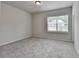 Neutral bedroom featuring plush carpeting, a window, and a ceiling light, perfect for relaxation at 1620 Branthaven Ln, Auburn, GA 30011
