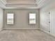 Bright bedroom features neutral walls, plush carpet, and a stylish tray ceiling at 1620 Branthaven Ln, Auburn, GA 30011