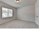 Clean and empty bedroom with a large window, carpet, and neutral walls, offering a calming space at 1620 Branthaven Ln, Auburn, GA 30011