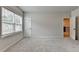 Neutral bedroom with a window, carpet, and view of the hallway, offering a blank canvas at 1620 Branthaven Ln, Auburn, GA 30011