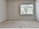 Comfortable bedroom featuring a window, carpet, and neutral paint perfect for relaxation and personalization at 1620 Branthaven Ln, Auburn, GA 30011