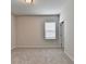 Light-filled bedroom with neutral walls, plush carpet, and a large window at 1620 Branthaven Ln, Auburn, GA 30011