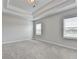 Bright bedroom features neutral walls, plush carpet, and a stylish tray ceiling at 1620 Branthaven Ln, Auburn, GA 30011