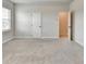 Bright bedroom features neutral walls, plush carpet, and a window at 1620 Branthaven Ln, Auburn, GA 30011