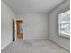 Neutral bedroom with a window, carpet, and a view into the hall, bright and move-in ready at 1620 Branthaven Ln, Auburn, GA 30011