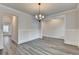 Charming dining room with hardwood style floors, chandelier lighting, and classic wainscoting detail at 1620 Branthaven Ln, Auburn, GA 30011