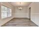 Elegant dining area with hardwood flooring, natural light, wainscoting, and modern chandelier at 1620 Branthaven Ln, Auburn, GA 30011
