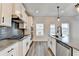 Modern kitchen featuring stainless steel appliances, granite countertops, and a stylish backsplash at 1620 Branthaven Ln, Auburn, GA 30011