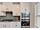 Stylish kitchen with granite countertops, a stainless steel oven, and white cabinets at 1620 Branthaven Ln, Auburn, GA 30011