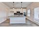 Open kitchen with an island, sleek stainless steel appliances, and granite counters at 1620 Branthaven Ln, Auburn, GA 30011