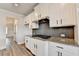 Modern kitchen features stainless steel appliances, granite countertops, and white cabinets at 1620 Branthaven Ln, Auburn, GA 30011
