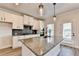 Kitchen with granite counters, stainless appliances, modern fixtures, and a center island at 1620 Branthaven Ln, Auburn, GA 30011