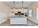 Well-lit kitchen with an island, granite countertops, and stainless steel appliances at 1620 Branthaven Ln, Auburn, GA 30011