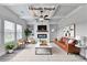 Staged living room showcases its fireplace, coffered ceiling, bright windows, and modern furnishings at 1620 Branthaven Ln, Auburn, GA 30011