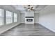 Bright living room with a fireplace, coffered ceiling, gray wood flooring, and lots of natural light at 1620 Branthaven Ln, Auburn, GA 30011