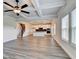Bright living room with coffered ceilings, wood flooring, and views into the modern kitchen at 1620 Branthaven Ln, Auburn, GA 30011