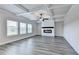Bright living room featuring modern flooring, a coffered ceiling, a fireplace, and bright windows at 1620 Branthaven Ln, Auburn, GA 30011