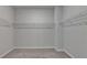 Spacious walk-in closet featuring neutral carpet and wire shelving for organized storage at 1620 Branthaven Ln, Auburn, GA 30011