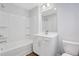 Bright bathroom features white cabinets, white shower and tile and modern fixtures at 1768 Evenstad Way, Smyrna, GA 30080