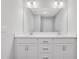 Bright bathroom with double vanity features white cabinets and a large mirror at 1768 Evenstad Way, Smyrna, GA 30080