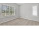 Neutral bedroom featuring carpet, light gray walls, and bright windows with white shutters at 1768 Evenstad Way, Smyrna, GA 30080