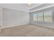 Bright bedroom features neutral walls, plush carpet, tray ceiling, and window with plantation shutters at 1768 Evenstad Way, Smyrna, GA 30080