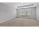 An empty bedroom with neutral carpet and paint, and a window with blinds at 1768 Evenstad Way, Smyrna, GA 30080