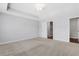 Large bedroom with neutral walls and carpet with 2 white doors and recessed ceiling lighting at 1768 Evenstad Way, Smyrna, GA 30080