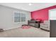 Bedroom includes playful pink accent wall, crib, chair, and large window with plantation shutters at 1768 Evenstad Way, Smyrna, GA 30080