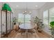 Light-filled dining area with a round table, plants, and natural light from the windows at 1768 Evenstad Way, Smyrna, GA 30080