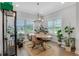 Light-filled dining area with a round table, plants, and natural light from the windows at 1768 Evenstad Way, Smyrna, GA 30080