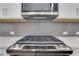 Gourmet kitchen featuring stainless steel gas range, stylish tile backsplash, and ample counter space at 1768 Evenstad Way, Smyrna, GA 30080