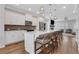 Modern kitchen featuring white cabinetry, stainless steel appliances, a large island, and stylish pendant lighting at 1768 Evenstad Way, Smyrna, GA 30080